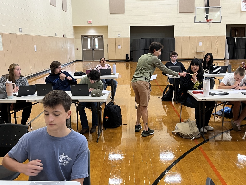 A drivers ed teacher talks to her students about the process of a DMV visit.