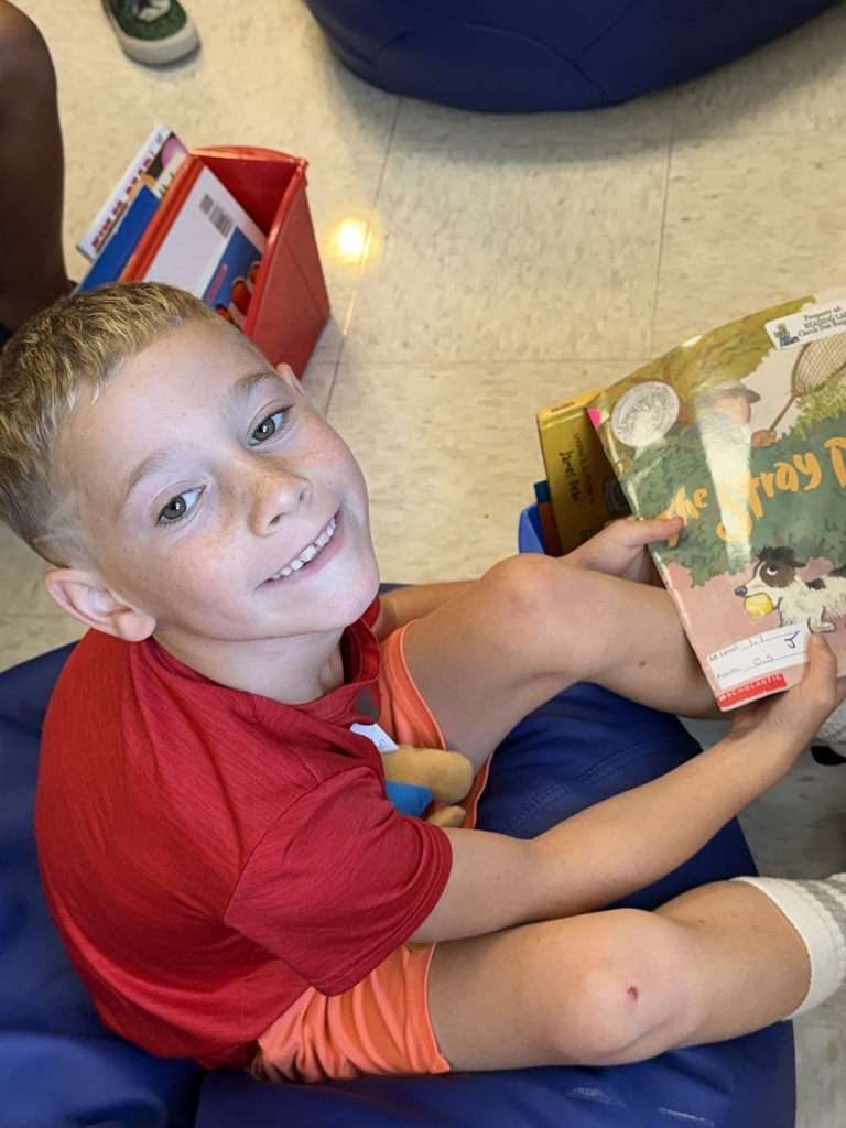 A first grader on the first day of school participates in a read to self activity.