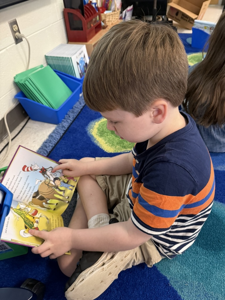 A first grader on the first day of school participates in a read to self activity.