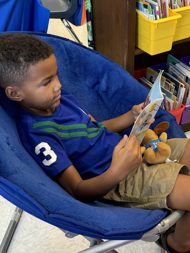 A first grader on the first day of school participates in a read to self activity.