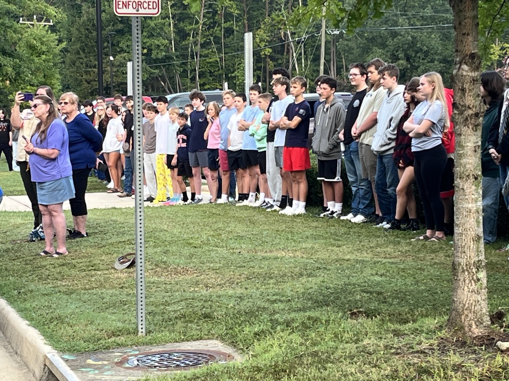 Students  listen during a 9/11 ceremony held in front of a middle school.