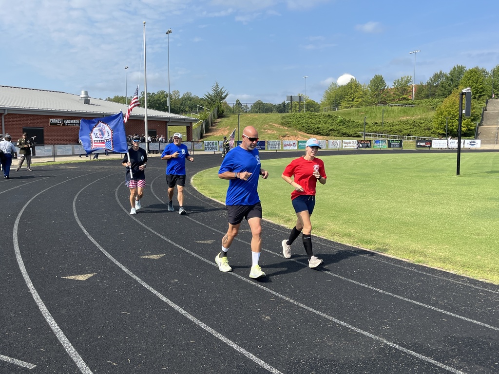 Runners run a shared 343 laps in a 9/11  remembrance ceremony held at the high school. 