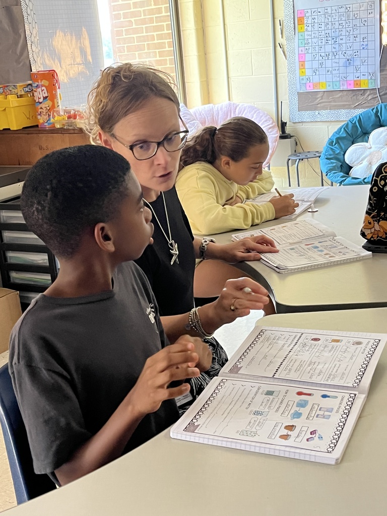 Fifth graders listen to a lesson on the law of conservation of matter.