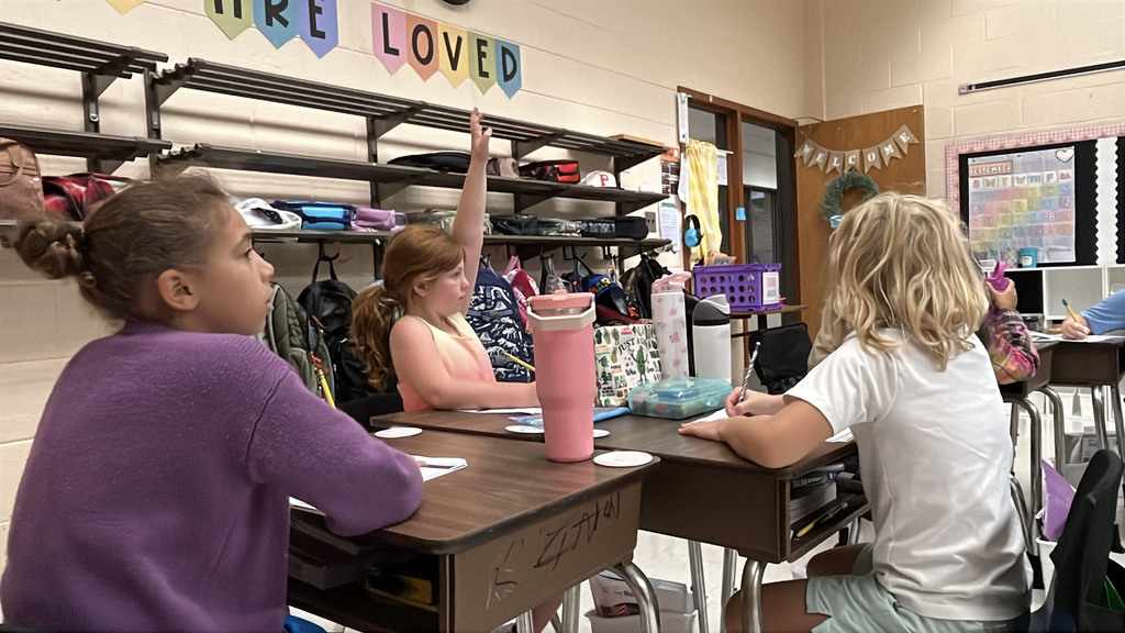 Students brainstorm ideas for a writing prompt about how to stay out of trouble .