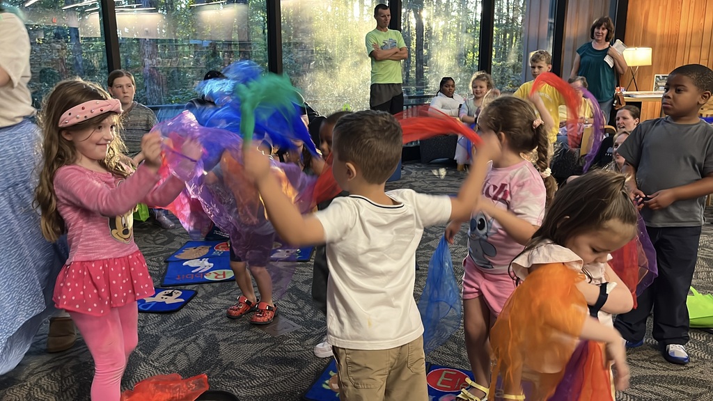 Children play play during a preschool literacy event at a library.