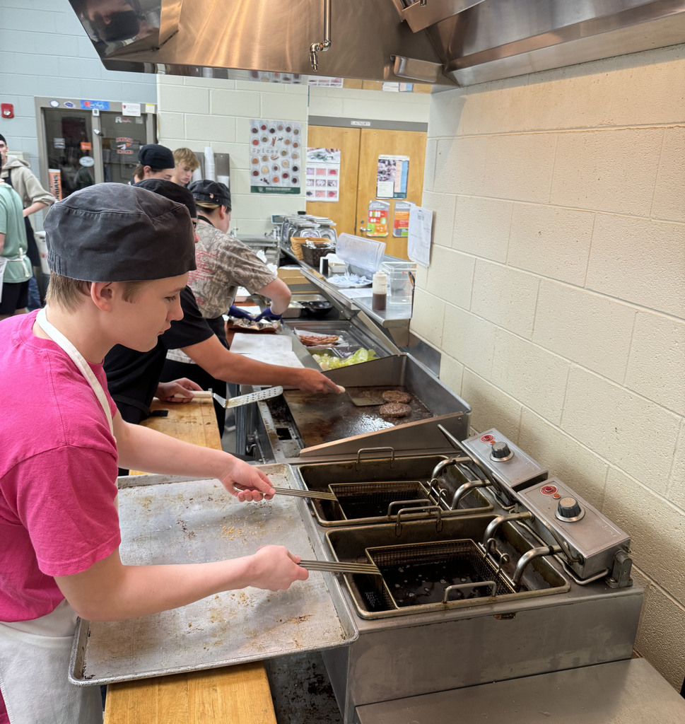 Culinary students prepare lunch in the kitchen of their student-run cafe, which is also their classroom.