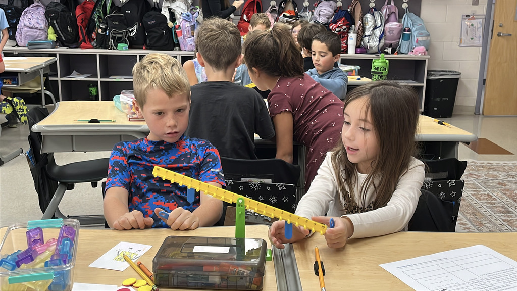 Groups of students  work with a balance to help them explore equality and inequality.