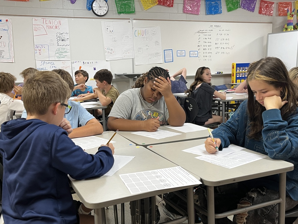 Students take an assessment in Spanish class to see what they know.