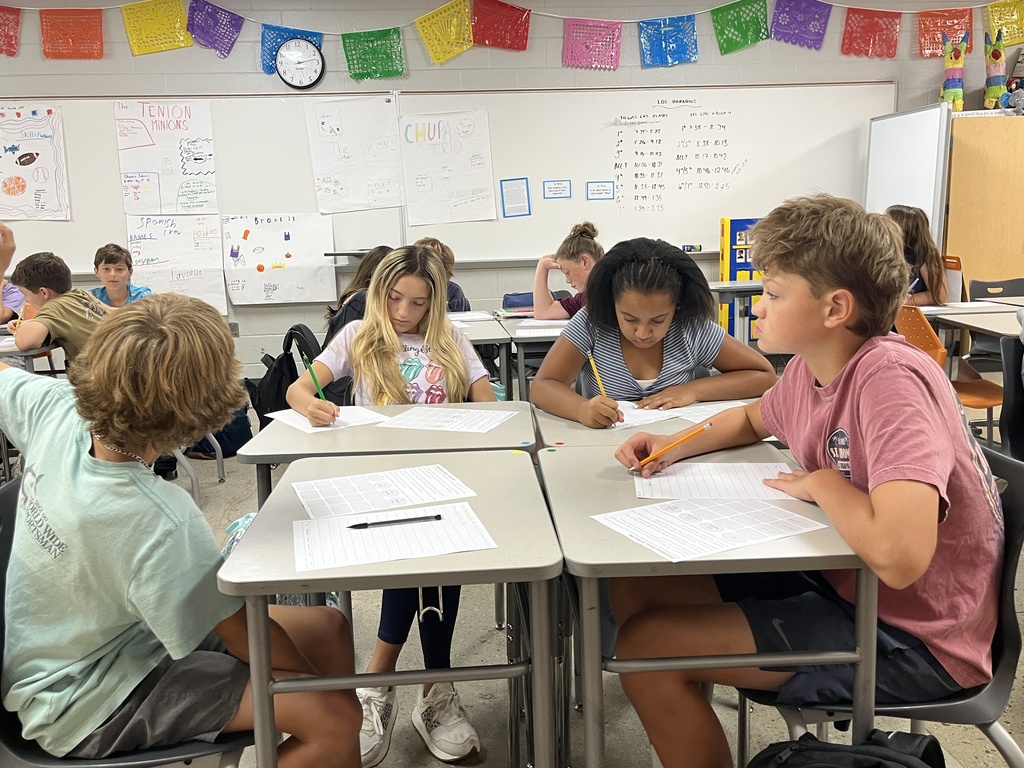 Students take an assessment in Spanish class to see what they know.