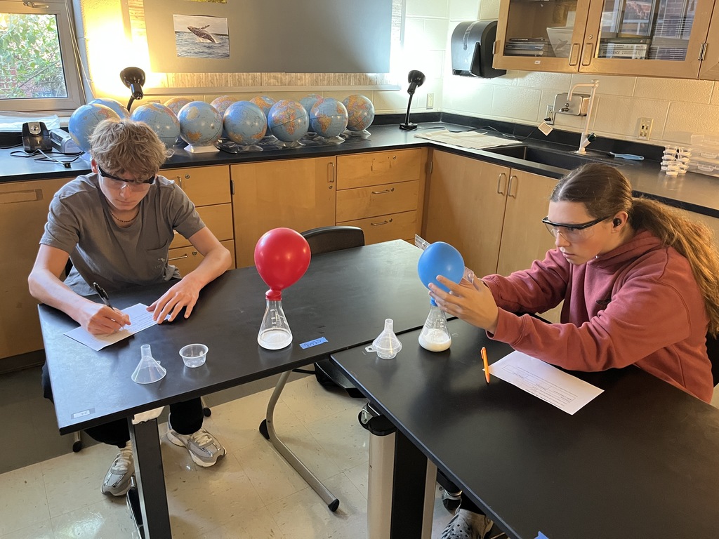 Students conduct an experiment where they combine baking soda and vinegar in a closed system, capture the carbon dioxide gas produced by the reaction in an attached balloon, and measure and record the balloons’ dimensions. 