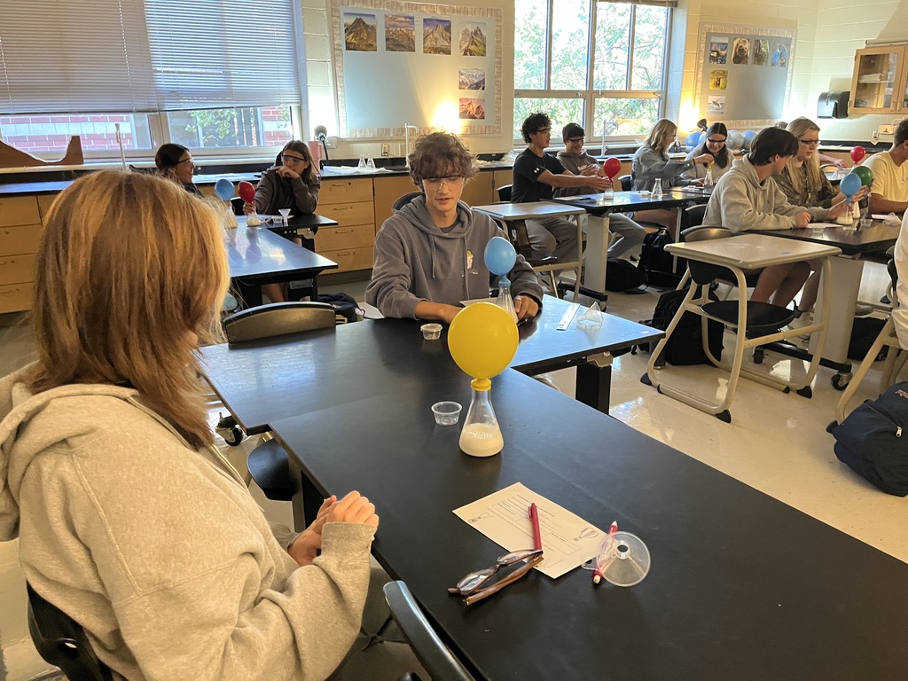 Students conduct an experiment where they combine baking soda and vinegar in a closed system, capture the carbon dioxide gas produced by the reaction in an attached balloon, and measure and record the balloons’ dimensions. 