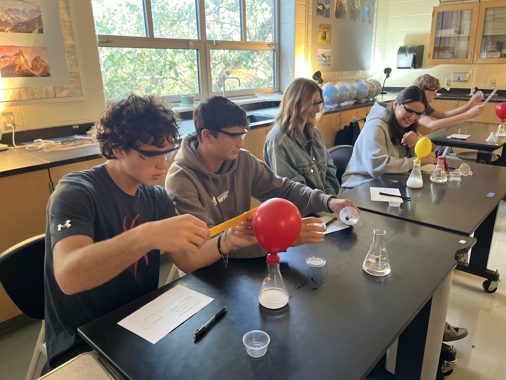 Students conduct an experiment where they combine baking soda and vinegar in a closed system, capture the carbon dioxide gas produced by the reaction in an attached balloon, and measure and record the balloons’ dimensions. 