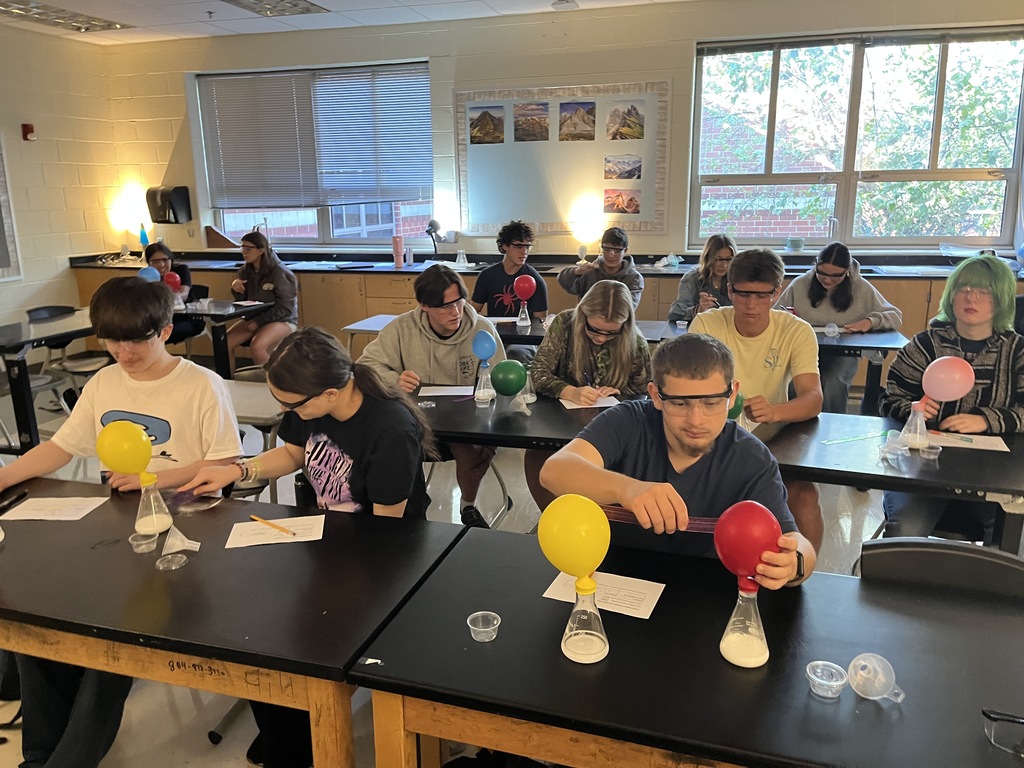 Students conduct an experiment where they combine baking soda and vinegar in a closed system, capture the carbon dioxide gas produced by the reaction in an attached balloon, and measure and record the balloons’ dimensions. 
