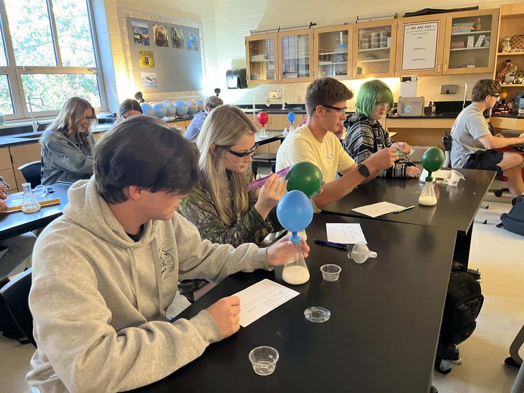 Students conduct an experiment where they combine baking soda and vinegar in a closed system, capture the carbon dioxide gas produced by the reaction in an attached balloon, and measure and record the balloons’ dimensions. 