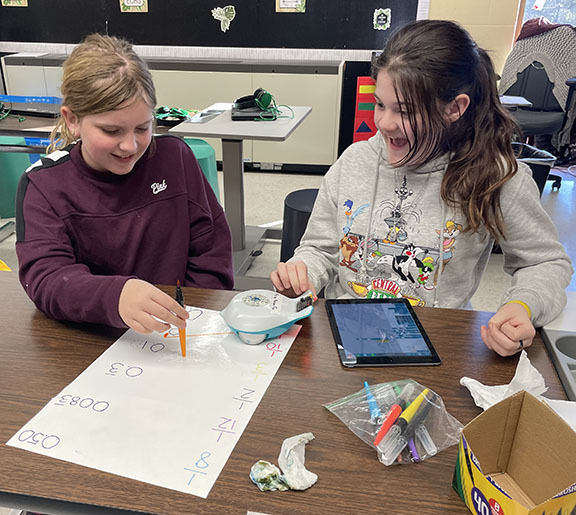 Two students use a Finch Robot to review math skills.