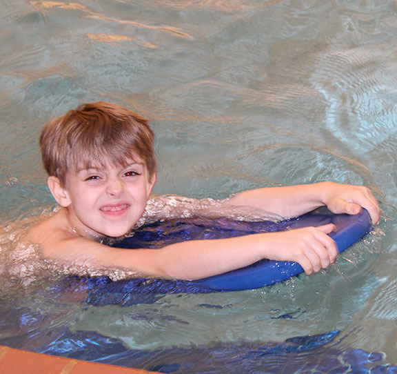A child learns to swim. 