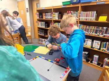 A group of children play with Legos