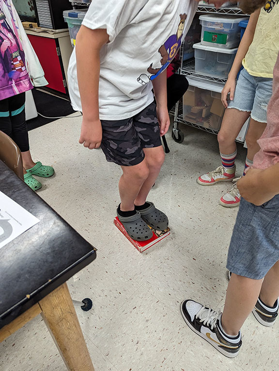 Student work on an activity to model the rock cycle.