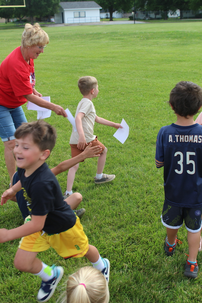 Kids handing off letters