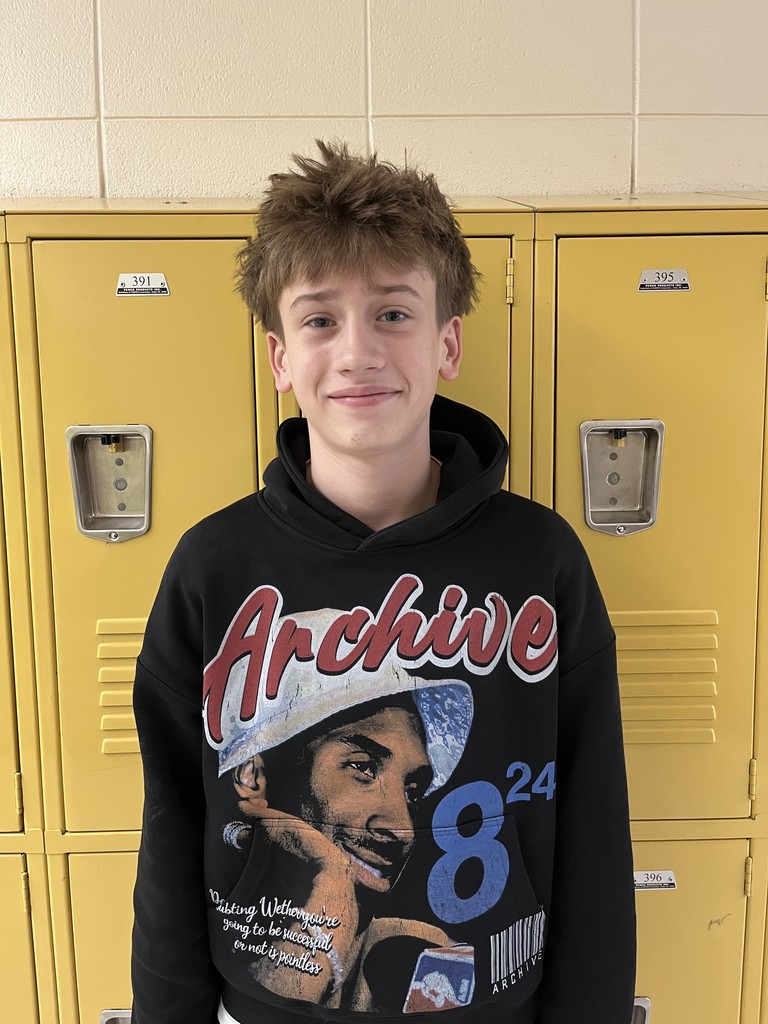 Student smiling in front of lockers