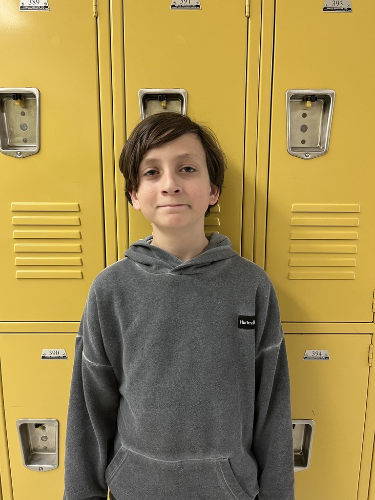 student smiling in front of lockers