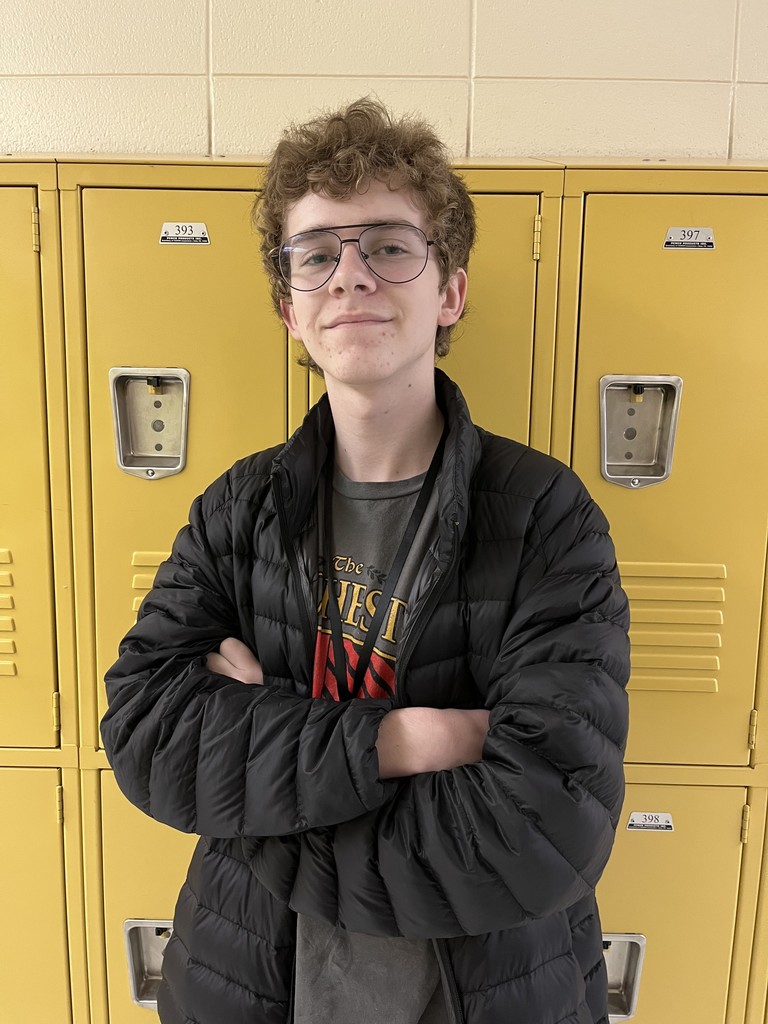 student smiling in front of lockers 