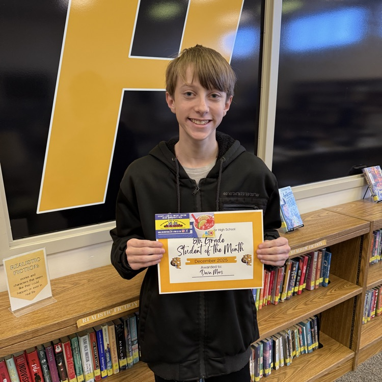 student of the month, Devin, holding his certificate 