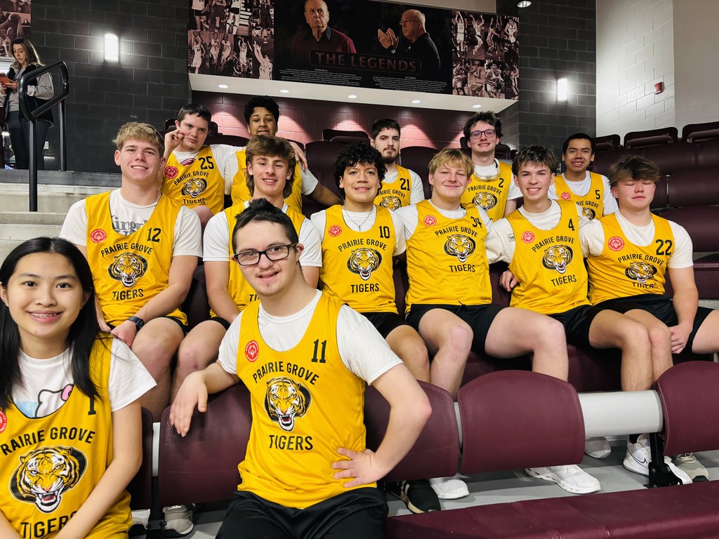 The PGHS unified cooperative sports basketball team in yellow tigers jerseys smiling together