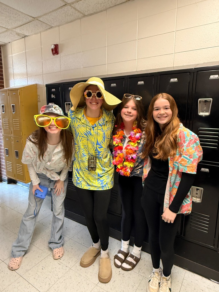 4 junior high girls dressed in tacky tourist attire to show their school spirit 