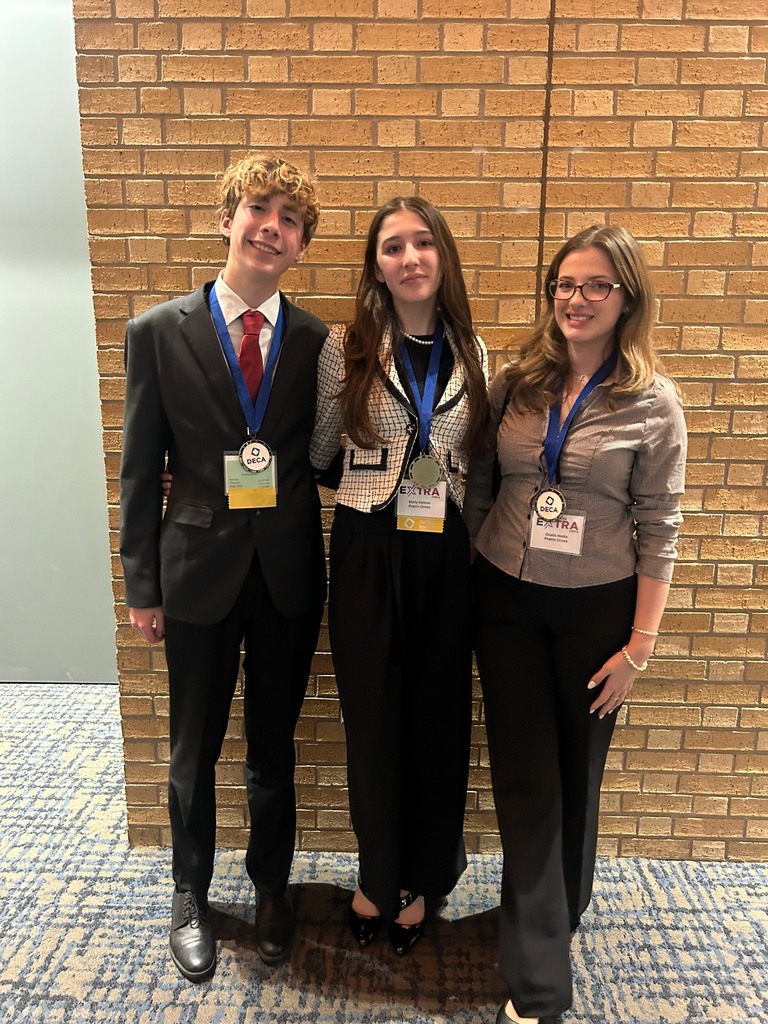 3 high school students smiling with their DECA medals