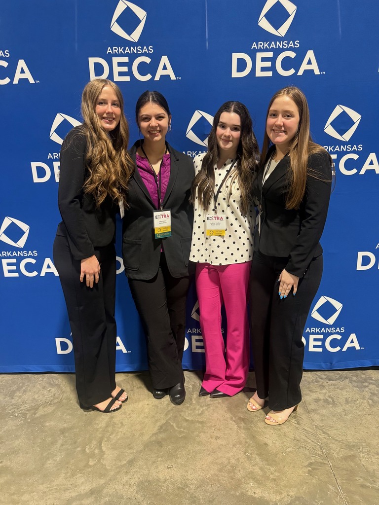 four high school girls dressed in business attire at the DECA conference