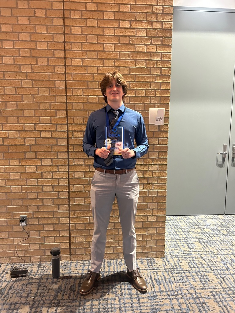 male student holding his DECA award