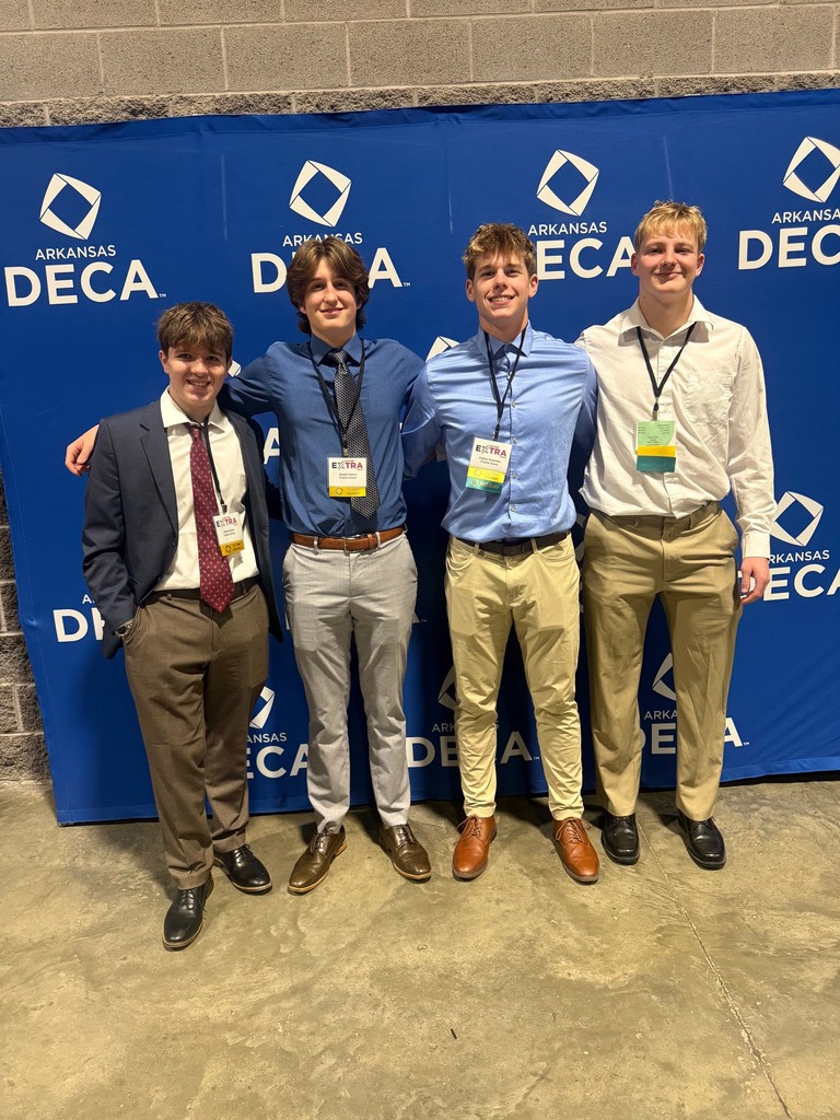 Four high school boys dress up at the DECA conference