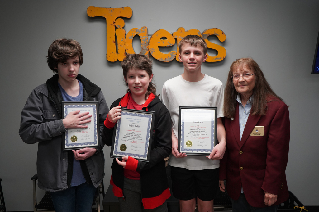 3 seventh grade boys holding their awards with representative from Elks Lodge 