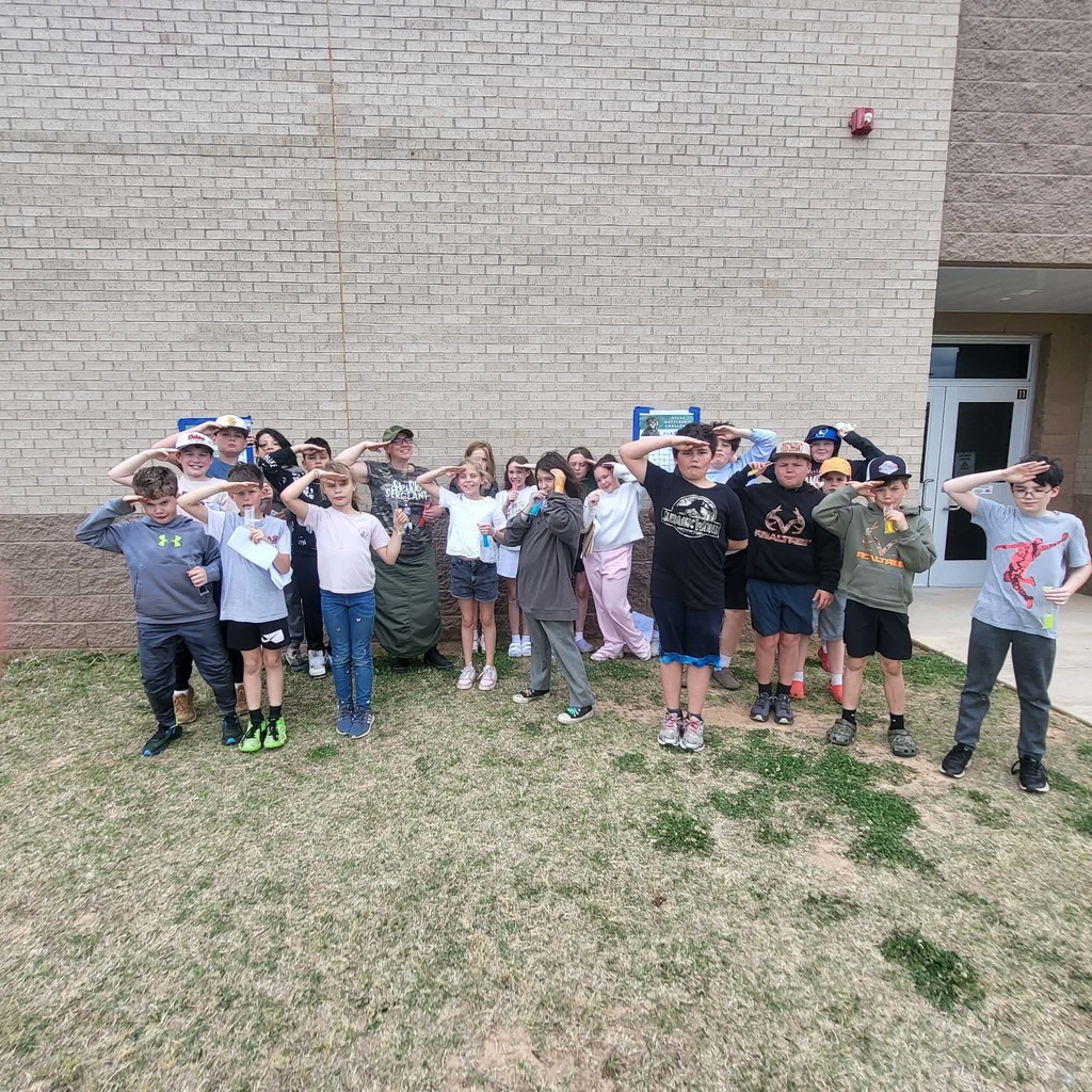 Students salute after completing ATLAS bootcamp.