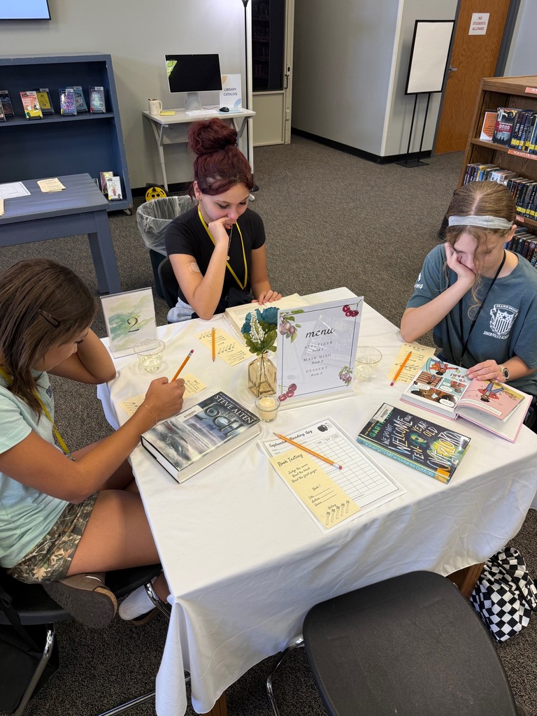 Students complete response forms during a book tasting.