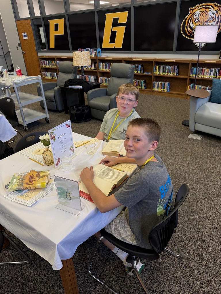 Students smile for the camera during a book tasting break in the library.