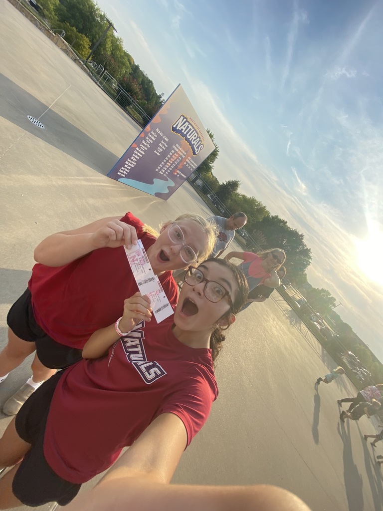 Students are headed into the Naturals baseball game and hold up their tickets.
