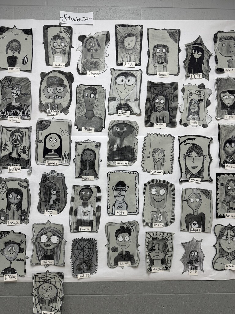 Black and white spooky portraits are displayed together on the wall