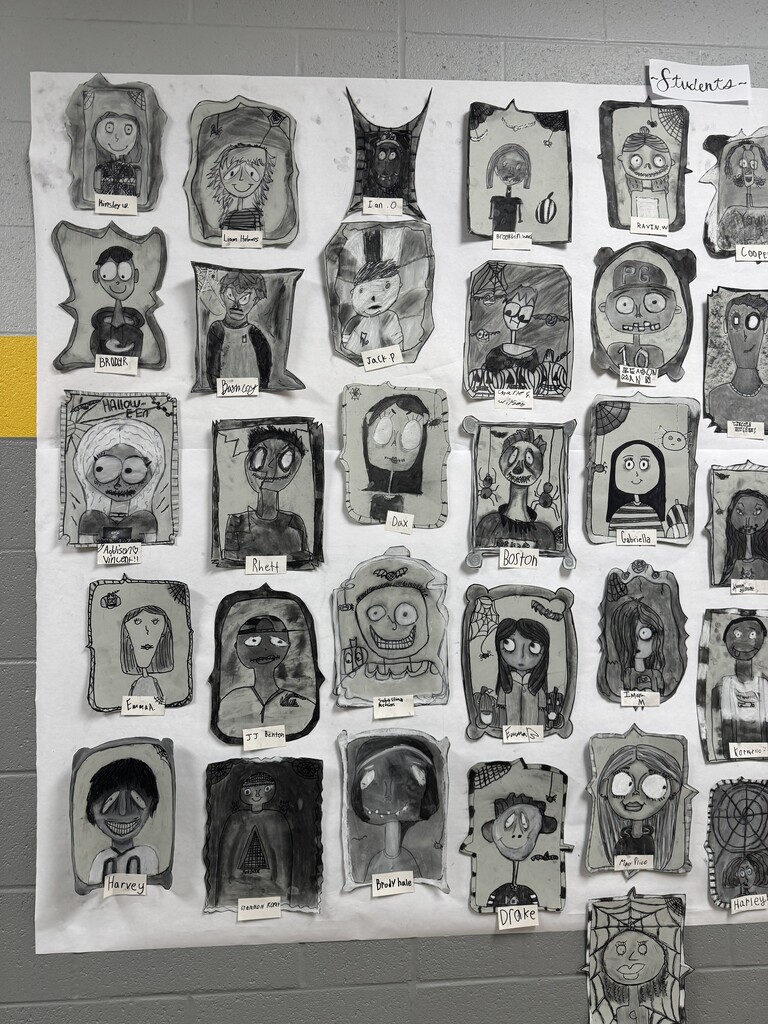 Black and white spooky portraits are displayed together on the wall
