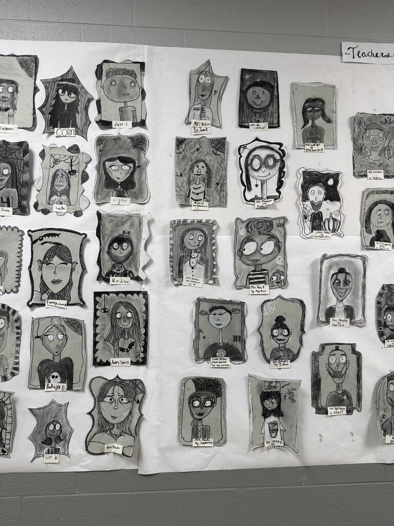 Black and white spooky portraits are displayed together on the wall