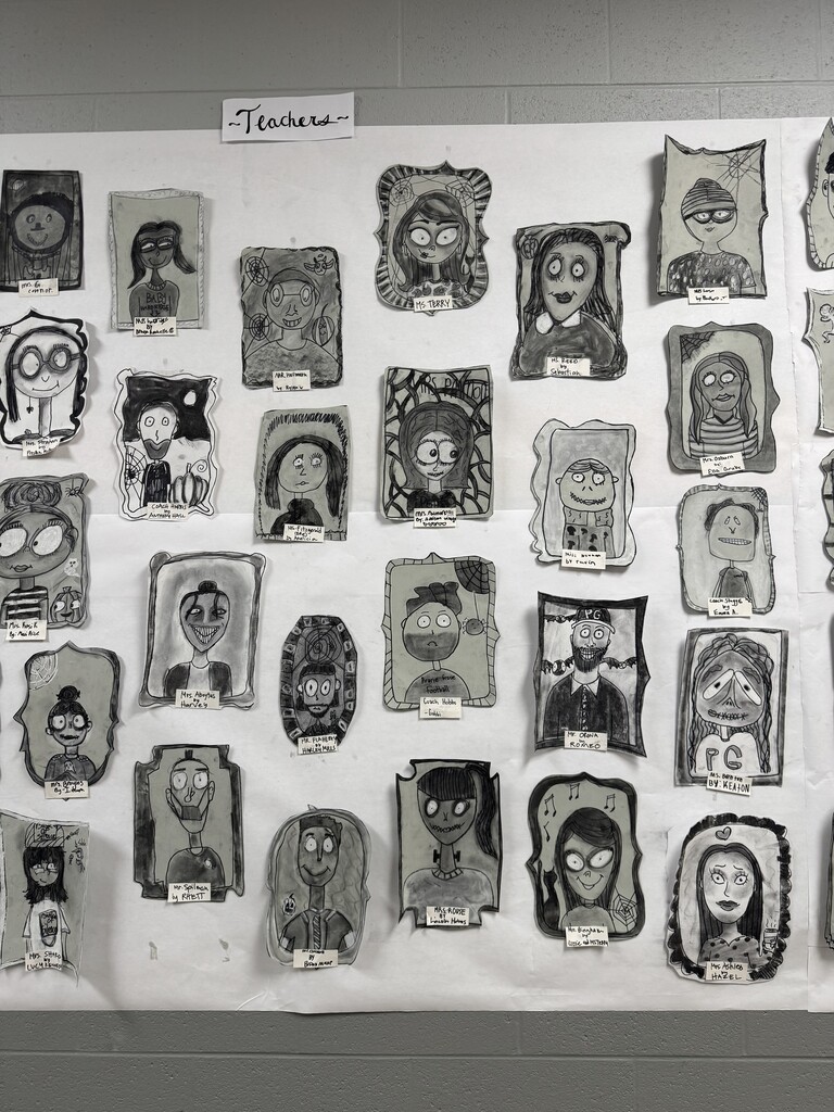 Black and white spooky portraits are displayed together on the wall