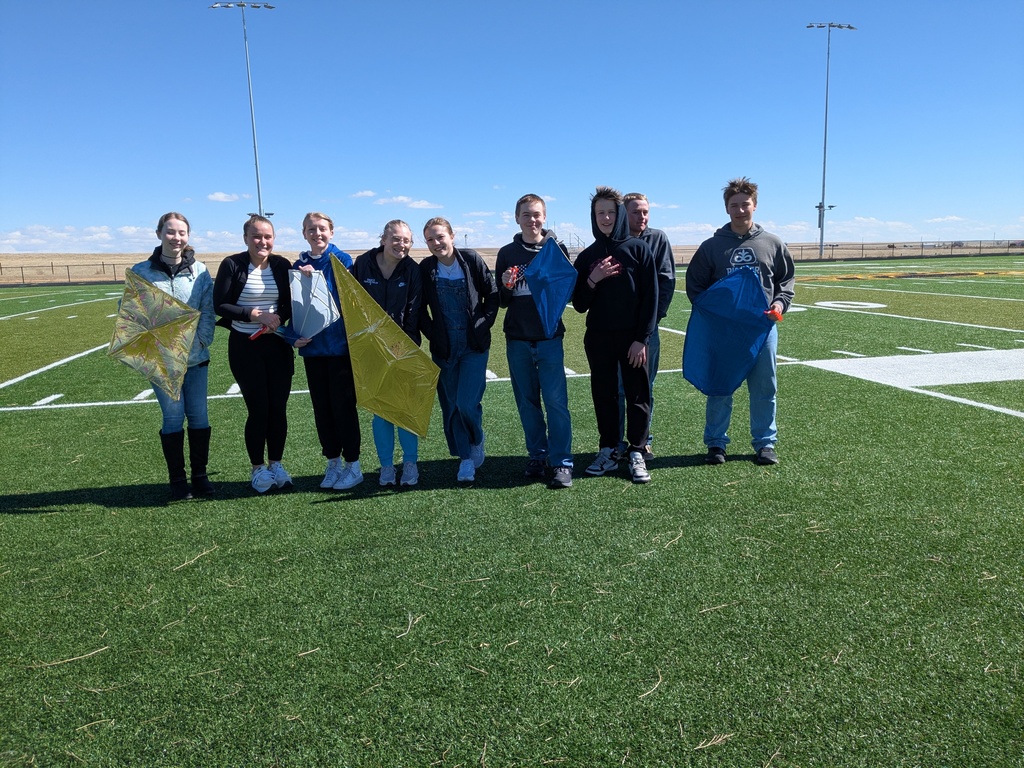 Geometry students holding their kites