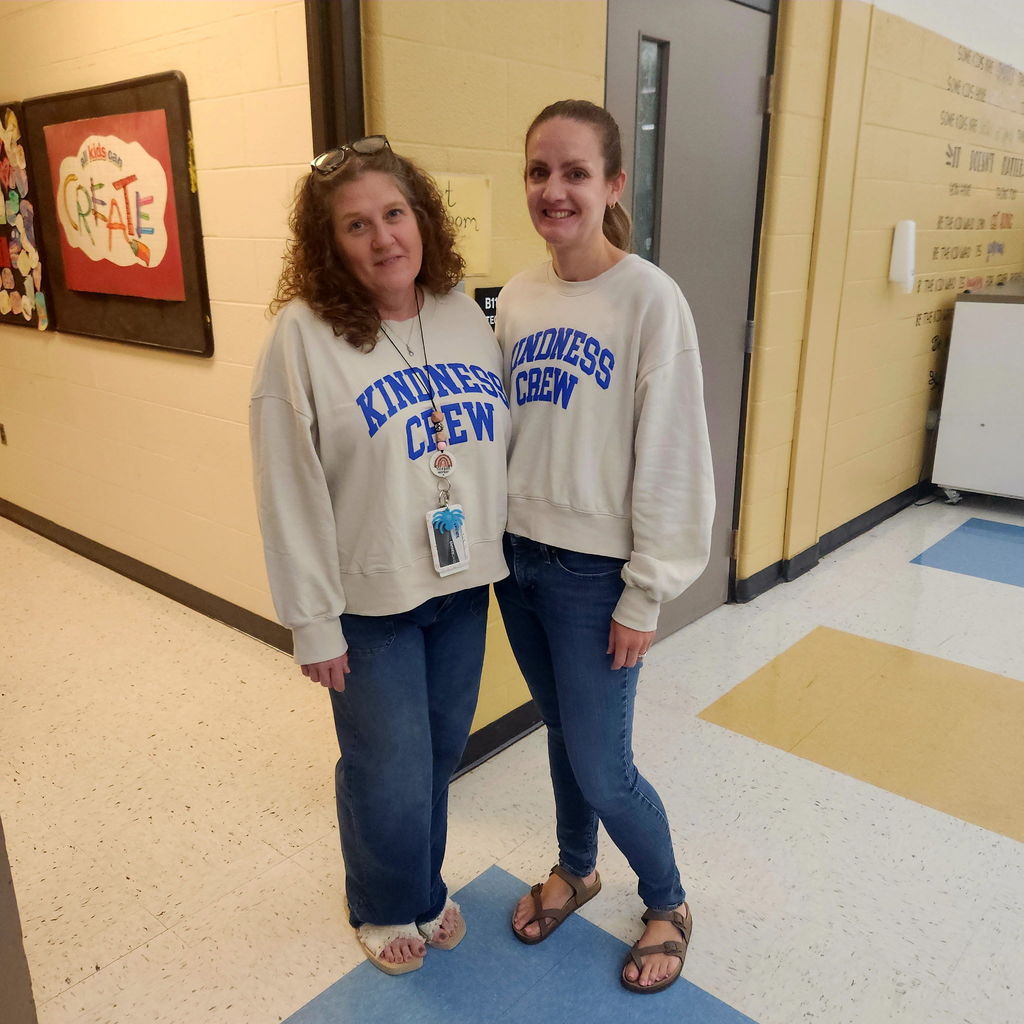two guidance counselors pose wearing kindness crew sweatshirts