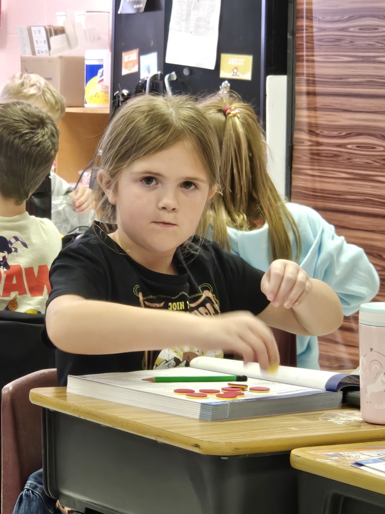 First graders use math manipulatives to help enhance understanding of mathematical concepts