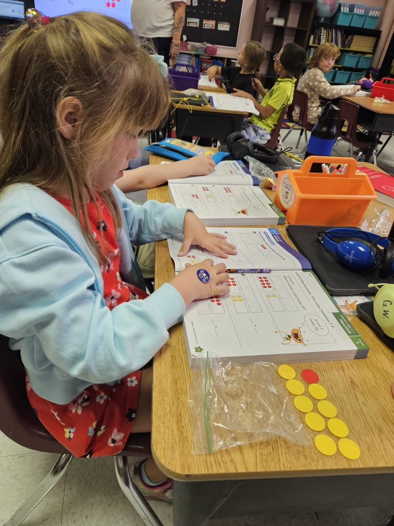 First graders use math manipulatives to help enhance understanding of mathematical concepts