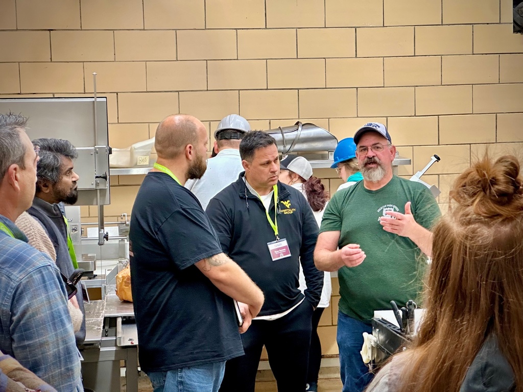 onlookers, men and women take a tour of a farm