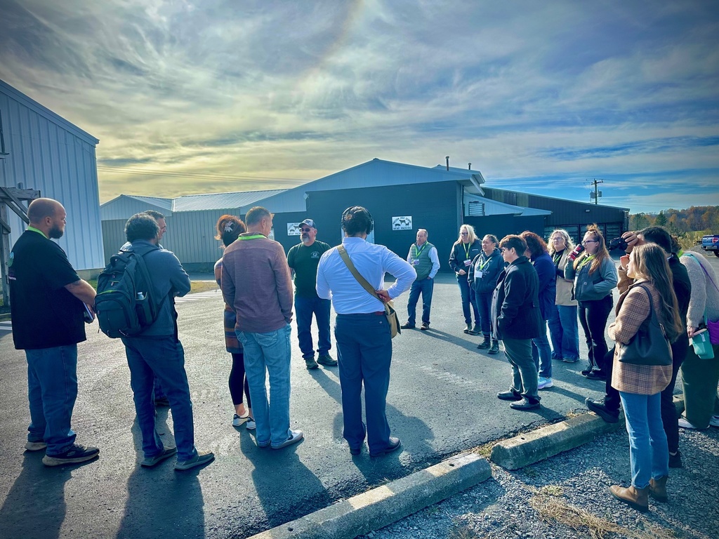 onlookers, men and women take a tour of a farm