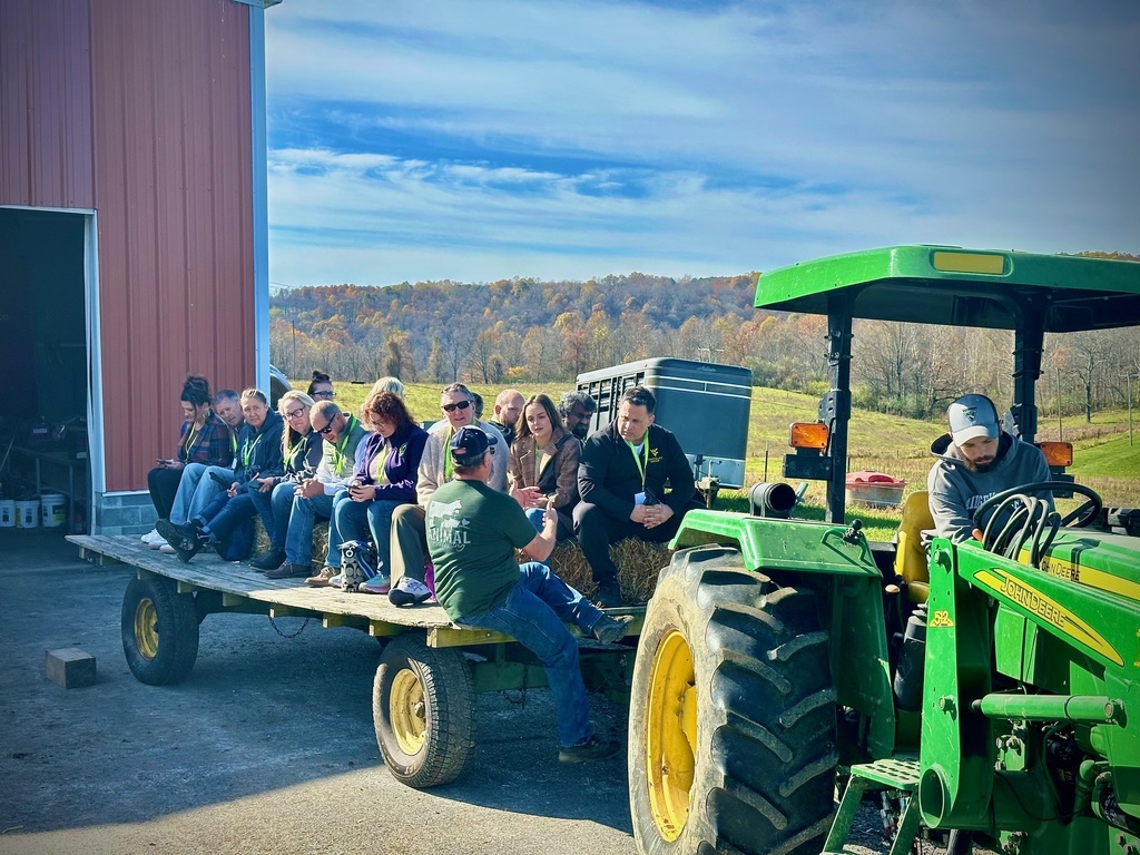onlookers, men and women take a tour of a farm