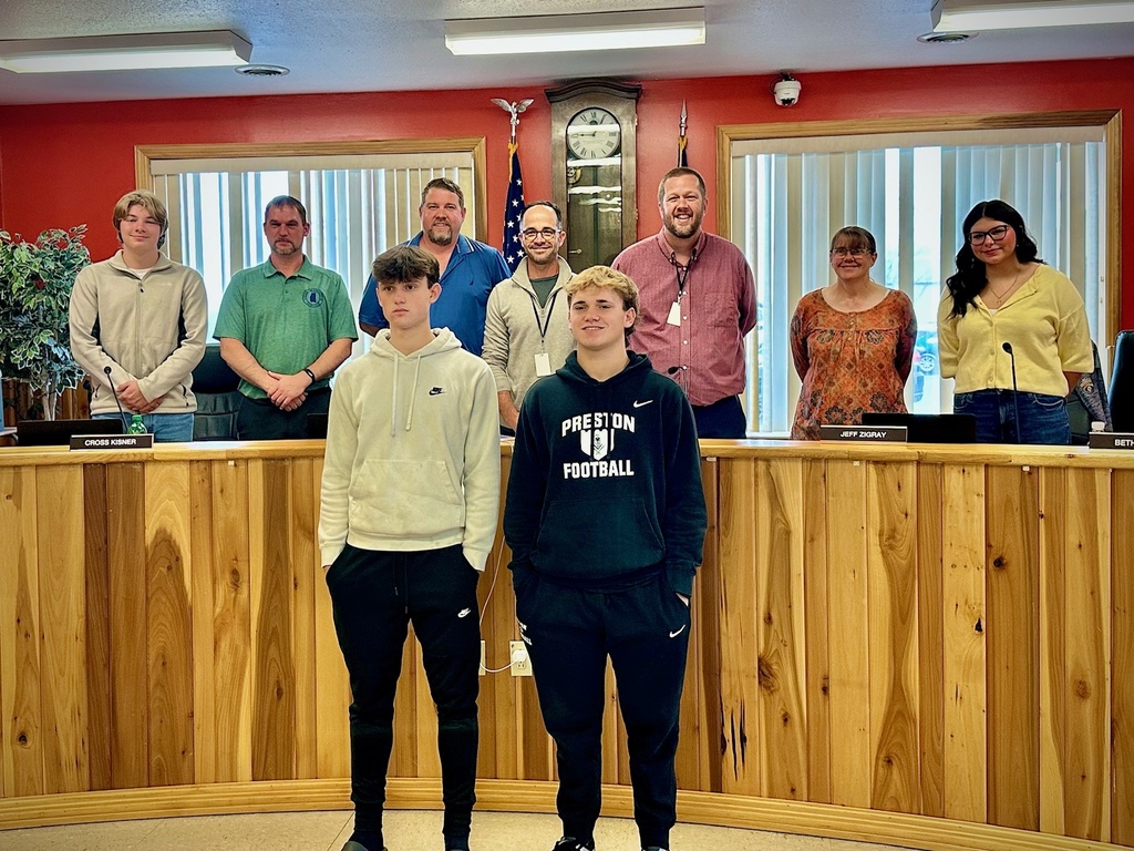students pose with board members to be recognized for achievement